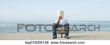 Man reading book at the beach View Large Photo Image Stock Photo - Man reading book at the beach. Fotosearch