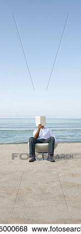 Man reading book at the beach View Large Photo Image Stock Photo - Man reading book at the beach. Fotosearch