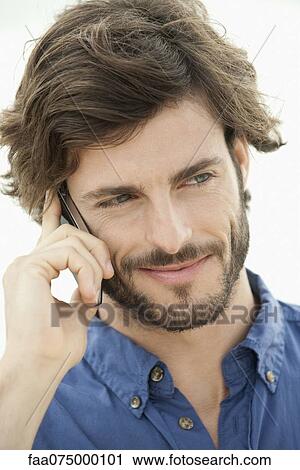 Man using cell phone outdoors, portrait View Large Photo Image Stock Image - Man using cell phone outdoors, portrait. Fotosearch