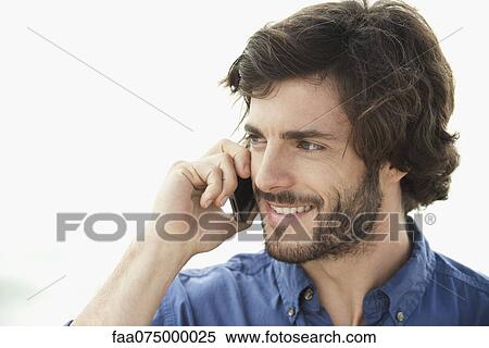 Stock Photography - Man using cell phone outdoors. Fotosearch