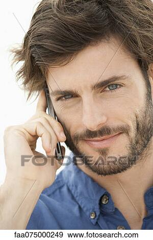 Stock Photo - Man using cell phone, portrait. Fotosearch