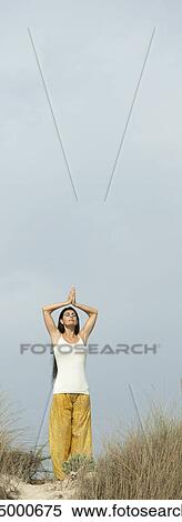 Mature woman doing prayer yoga position on beach View Large Photo Image Stock Photography - Mature woman doing prayer yoga position on beach. Fotosearch