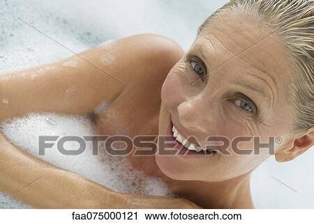 Mature woman enjoying bubble bath, tilt View Large Photo Image Stock Image - Mature woman enjoying bubble bath, tilt. Fotosearch