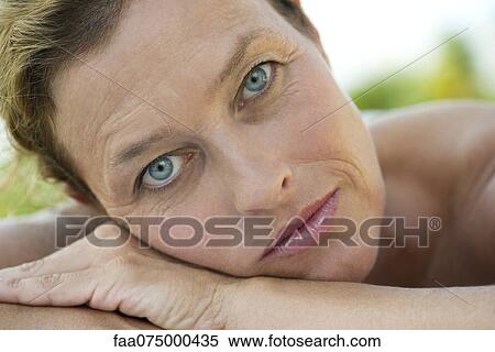 Mature woman resting head on arms, portrait View Large Photo Image Stock Photography - Mature woman resting head on arms, portrait. Fotosearch