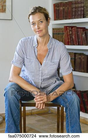 Picture - Mature woman sitting in chair, portrait. Fotosearch