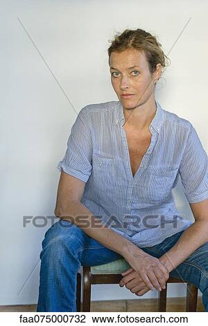 Mature woman sitting in chair, portrait View Large Photo Image Stock Image - Mature woman sitting in chair, portrait. Fotosearch