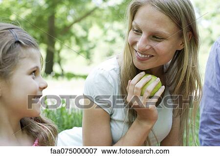 Mother and daughter outdoors, looking at each other View Large Photo Image Stock Photo - Mother and daughter outdoors, looking at each other. Fotosearch