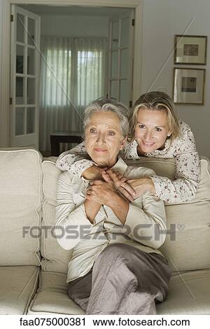 Mother and daughter spending time in living room View Large Photo Image Stock Image - Mother and daughter spending time in living room. Fotosearch