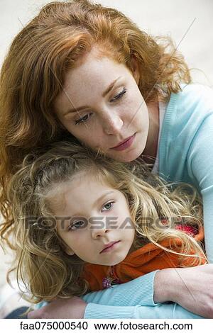 Mother embracing daughter, portrait View Large Photo Image Stock Image - Mother embracing daughter, portrait. Fotosearch