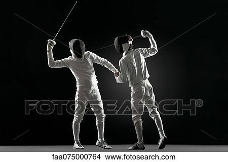 Picture - One fencer pointing fencing foil at the other fencer. Fotosearch