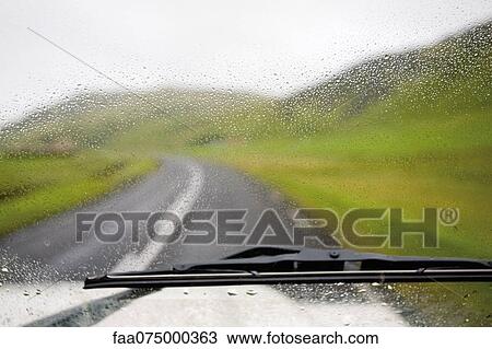 Road and countryside viewed through wet car windshield View Large Photo Image Stock Image - Road and countryside viewed through wet car windshield. Fotosearch
