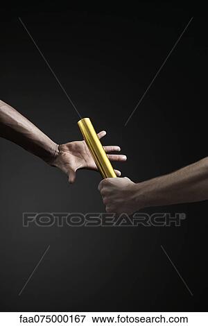 Runners passing baton, cropped View Large Photo Image Stock Photo - Runners passing baton, cropped. Fotosearch
