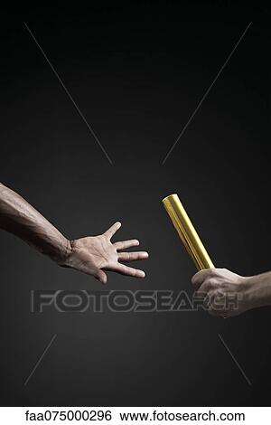Runners passing baton, cropped View Large Photo Image Stock Photograph - Runners passing baton, cropped. Fotosearch