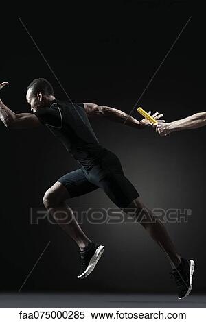 Runners passing baton View Large Photo Image Stock Photography - Runners passing baton. Fotosearch