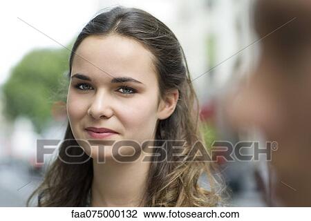 Smiling young woman outdoors View Large Photo Image Stock Image - Smiling young woman outdoors. Fotosearch