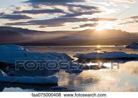 Sun setting over Jokulsarlon glacial lagoon, Iceland View Large Photo Image Stock Photo - Sun setting over Jokulsarlon glacial lagoon, Iceland. Fotosearch