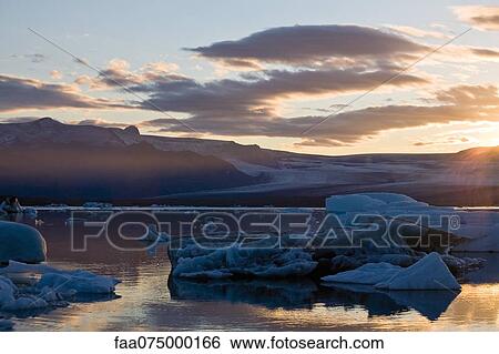 Sun setting over Jokulsarlon glacial lagoon, Iceland View Large Photo Image Stock Photograph - Sun setting over Jokulsarlon glacial lagoon, Iceland. Fotosearch