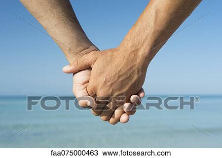 Two men holding hands, cropped View Large Photo Image Stock Image - Two men holding hands, cropped. Fotosearch