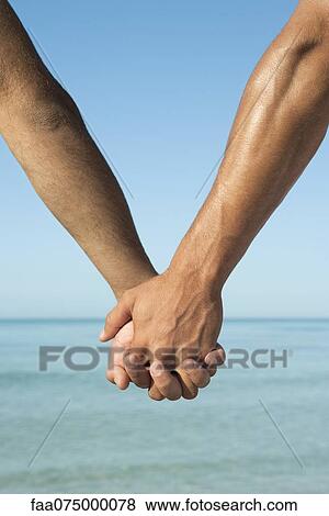 Two men holding hands, cropped View Large Photo Image Stock Photo - Two men holding hands, cropped. Fotosearch