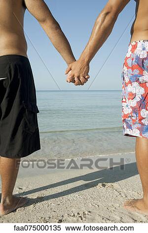 Two men holding hands, cropped View Large Photo Image Stock Photography - Two men holding hands, cropped. Fotosearch