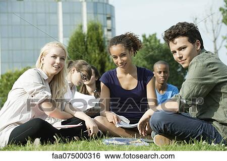 University students studying together outdoors on grass, focus on one woman View Large Photo Image Stock Photograph - University students studying together outdoors on grass, focus on one woman. Fotosearch