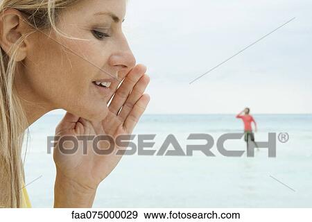 Woman appearing to whisper to tiny man View Large Photo Image Stock Photo - Woman appearing to whisper to tiny man. Fotosearch