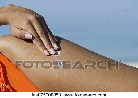 Woman applying suncreen at the beach, cropped View Large Photo Image Stock Image - Woman applying suncreen at the beach, cropped. Fotosearch