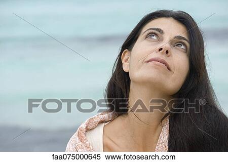 Woman at the beach, looking up View Large Photo Image Stock Photography - Woman at the beach, looking up. Fotosearch