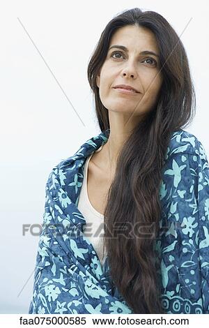 Stock Photography - Woman daydreaming outdoors, portrait. Fotosearch