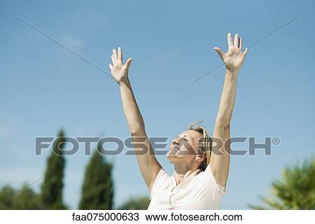 Woman in sun salutation pose outdoors View Large Photo Image Stock Image - Woman in sun salutation pose outdoors. Fotosearch