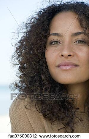 Woman looking confidently at camera, portrait View Large Photo Image Stock Image - Woman looking confidently at camera, portrait. Fotosearch