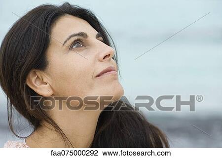 Woman looking up in thought, portrait View Large Photo Image Stock Image - Woman looking up in thought, portrait. Fotosearch