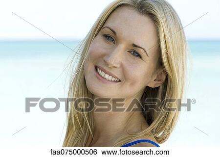 Stock Photograph - Woman outdoors, smiling, portrait. Fotosearch