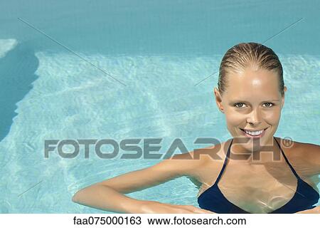 Woman relaxing in pool, portrait View Large Photo Image Stock Image - Woman relaxing in pool, portrait. Fotosearch