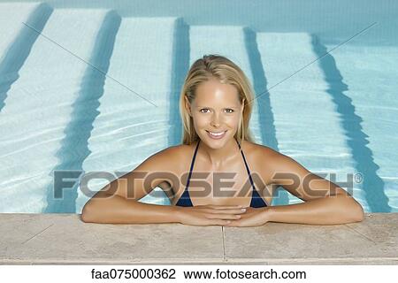 Woman relaxing in pool, portrait View Large Photo Image Stock Image - Woman relaxing in pool, portrait. Fotosearch
