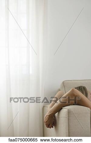 Woman relaxing on sofa, cropped View Large Photo Image Stock Photography - Woman relaxing on sofa, cropped. Fotosearch