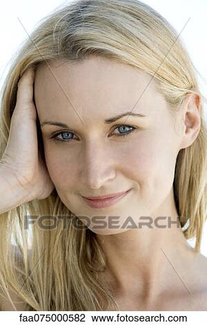 Stock Image - Woman smiling at camera, portrait. Fotosearch