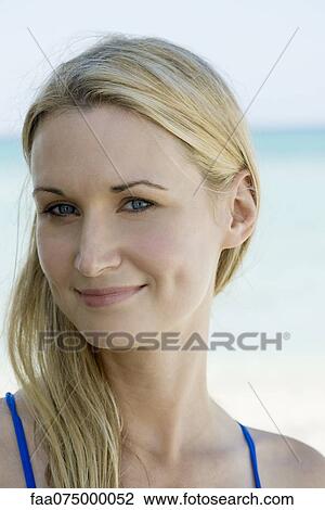 Stock Image - Woman smiling outdoors, portrait. Fotosearch