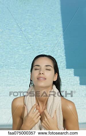 Woman sunbathing beside pool View Large Photo Image Stock Photo - Woman sunbathing beside pool. Fotosearch