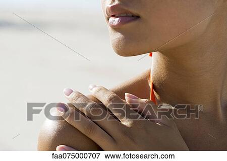 Woman touching bare shoulder at the beach, cropped View Large Photo Image Stock Photo - Woman touching bare shoulder at the beach, cropped. Fotosearch