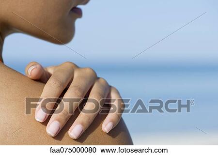 Woman touching bare shoulder, cropped View Large Photo Image Stock Image - Woman touching bare shoulder, cropped. Fotosearch