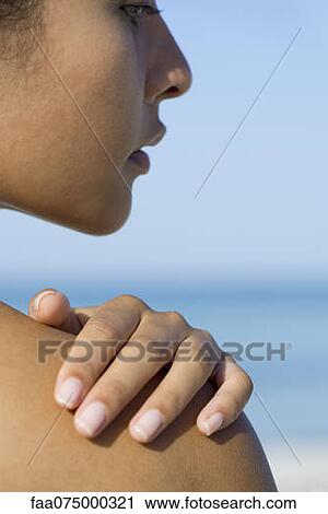 Woman touching bare shoulder, cropped View Large Photo Image Stock Image - Woman touching bare shoulder, cropped. Fotosearch