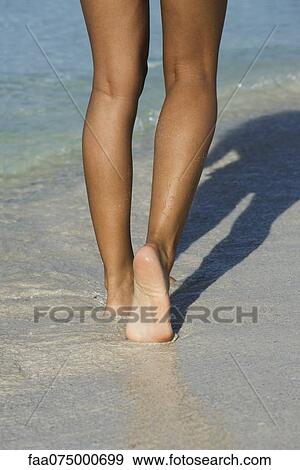 Woman walking in surf at the beach, low section View Large Photo Image Stock Photo - Woman walking in surf at the beach, low section. Fotosearch