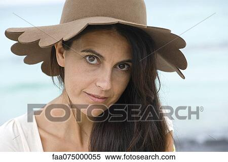 Stock Photography - Woman wearing sun hat, portrait. Fotosearch