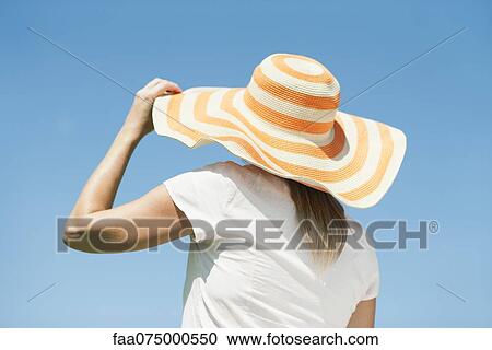 Woman wearing sun hat, rear view View Large Photo Image Stock Image - Woman wearing sun hat, rear view. Fotosearch