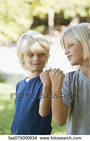 Young brothers bumping fists View Large Photo Image Picture - Young brothers bumping fists. Fotosearch