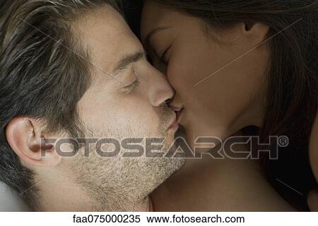 Stock Photography - Young coupld kissing. Fotosearch