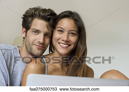 Young couple, low angle view View Large Photo Image Stock Image - Young couple, low angle view. Fotosearch