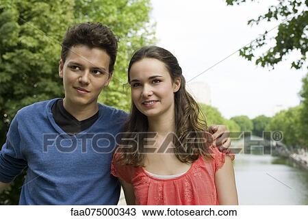 Stock Image - Young couple outdoors, portrait. Fotosearch