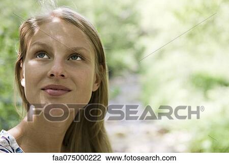 Young woman in nature, portrait View Large Photo Image Stock Image - Young woman in nature, portrait. Fotosearch